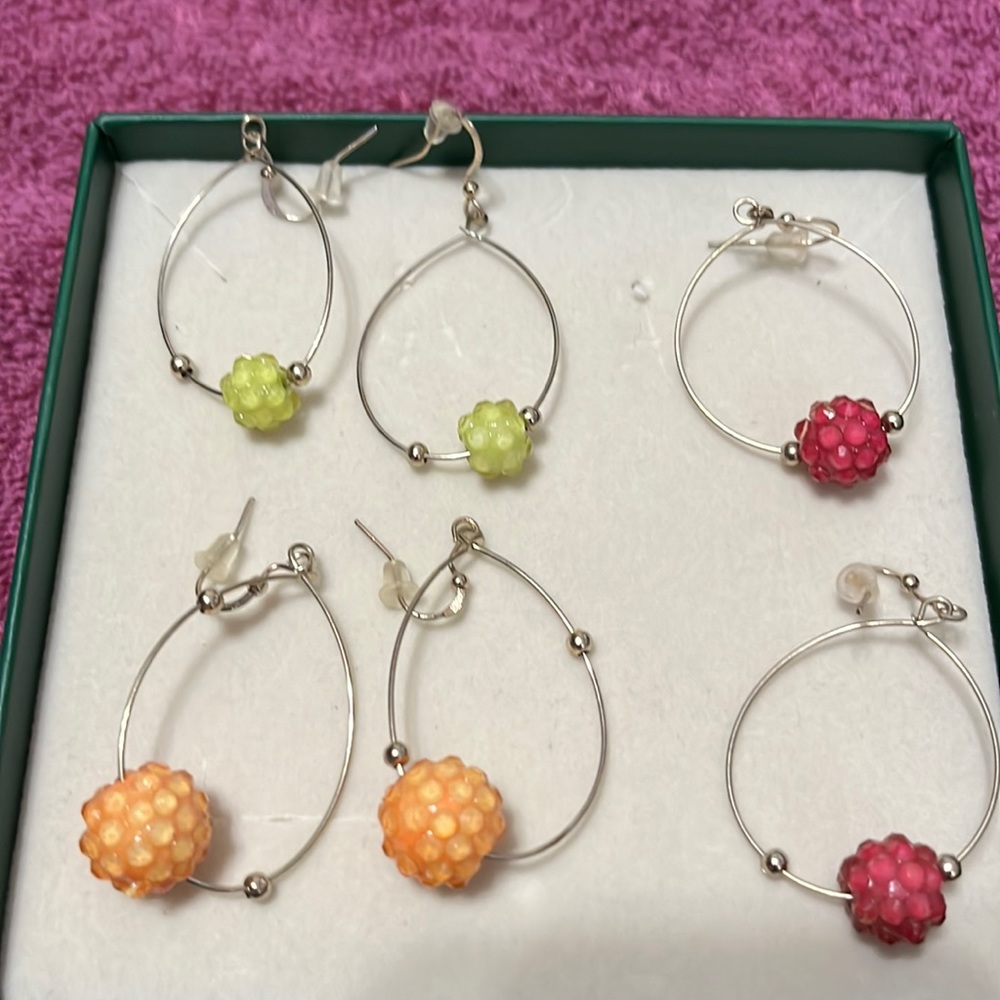 3 sets of hoop earrings with orange pink and green stones